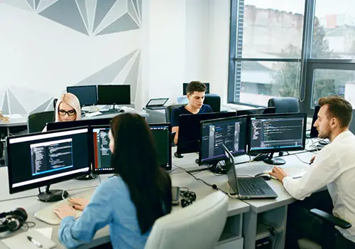 Full time employees working at their computers in a modern office.