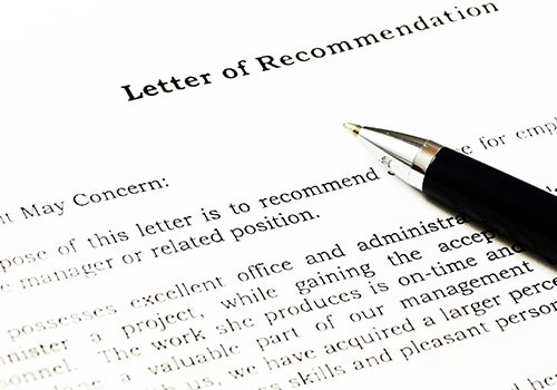 A pen on top of a letter of recommendation.