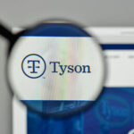 Magnifying glass closeup of Tyson foods website logo.