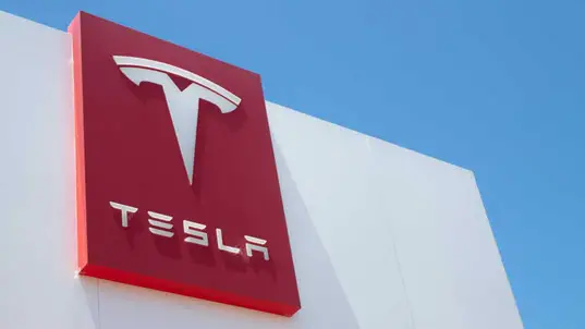 Tesla logo on the front of a Tesla showroom.