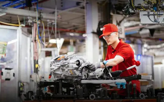 A Tesla employee hard at work in a Tesla manufacturing plant.